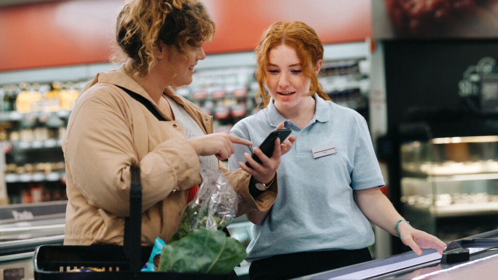 Grocery Store employee assisting a customer