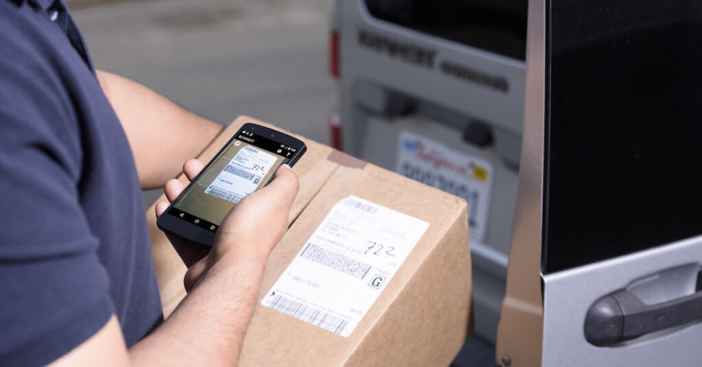 Delivery man scanning package label