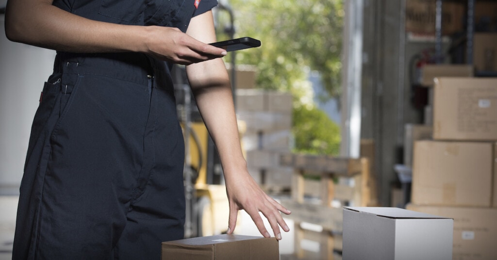 Delivery man scanning package label
